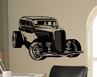 May include: Black and white silhouette of a vintage hot rod car with a large grill and rounded headlights. The car is facing forward and has a large, rounded bonnet.