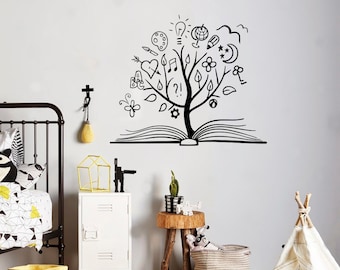 May include: Black and white wall decal of a tree growing out of an open book. The tree is decorated with various symbols including a light bulb, a heart, a music note, a flower, and a star.