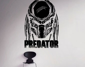 May include: Black and white Predator mask wall decal with the word "PREDATOR" printed below the mask.