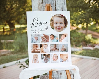 May include: A white poster board with the name "Rosie" and the text "My First Year 09.10.22" displayed on an easel. The poster board features a collage of 12 photos of a baby girl.