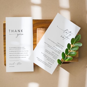 May include: A white thank you card with black text that reads "Thank you" and "To our parents, wedding party and all of our honored guests for helping make this the best day of our lives. Thank you for the endless laughter, love and support that you have contributed to our lives. We hope you enjoy tonight's celebration! Carol + Steve 09.10.20XX". A white menu card with black text that reads "Let's eat!" and lists the courses for the wedding reception: "First Course: Cornish Crab Bisque with poached scallops and parsley toasts", "Second Course: Salad of greens with roasted butternut squash, toasted hazelnuts and goat cheese", "Main Course: Roasted leg of English Lamb with rosemary, garlic and dauphinoise potatoes", "Pan Fried Fillet of Free Range Chicken with button onions, mushrooms, sweetcorn pancake", "Dessert: Wedding Cake, Vanilla Pannacotta with a compote of fruits, Glazed Lemon Tart".