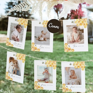 May include: A set of six white rectangular photo cards hanging on a twine string, each featuring a yellow honeycomb pattern, a small bee illustration, and a baby photograph labeled from newborn to five months with cursive text and dates.
