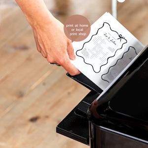 May include: A black printer is shown with a hand inserting a printed sheet of paper. The paper has a crossword puzzle with the words "Dip & Solve" and the text "print at home or local print shop".