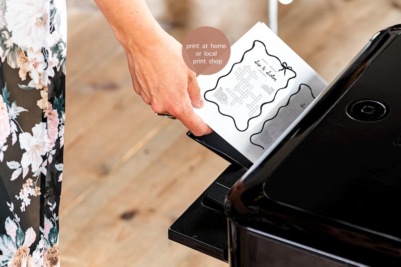 May include: A black printer is shown with a hand inserting a printed sheet of paper. The paper has a crossword puzzle with the words "Dip & Solve" and the text "print at home or local print shop".