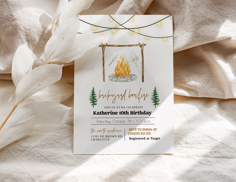 May include: A white invitation card with a watercolor illustration of a campfire with string lights above. The text reads "Backyard Bonfire" and "Join us as we celebrate Katherine 10th Birthday" with the date and time. The invitation also includes the address and RSVP information.