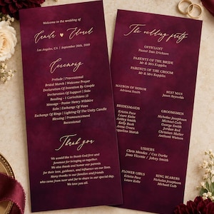 May include: Two rectangular wedding program cards with a deep burgundy watercolor background and gold script text. The cards list the ceremony order, wedding party members, and a thank you message for the wedding of Camila and Elvad on September 20th, 2019.
