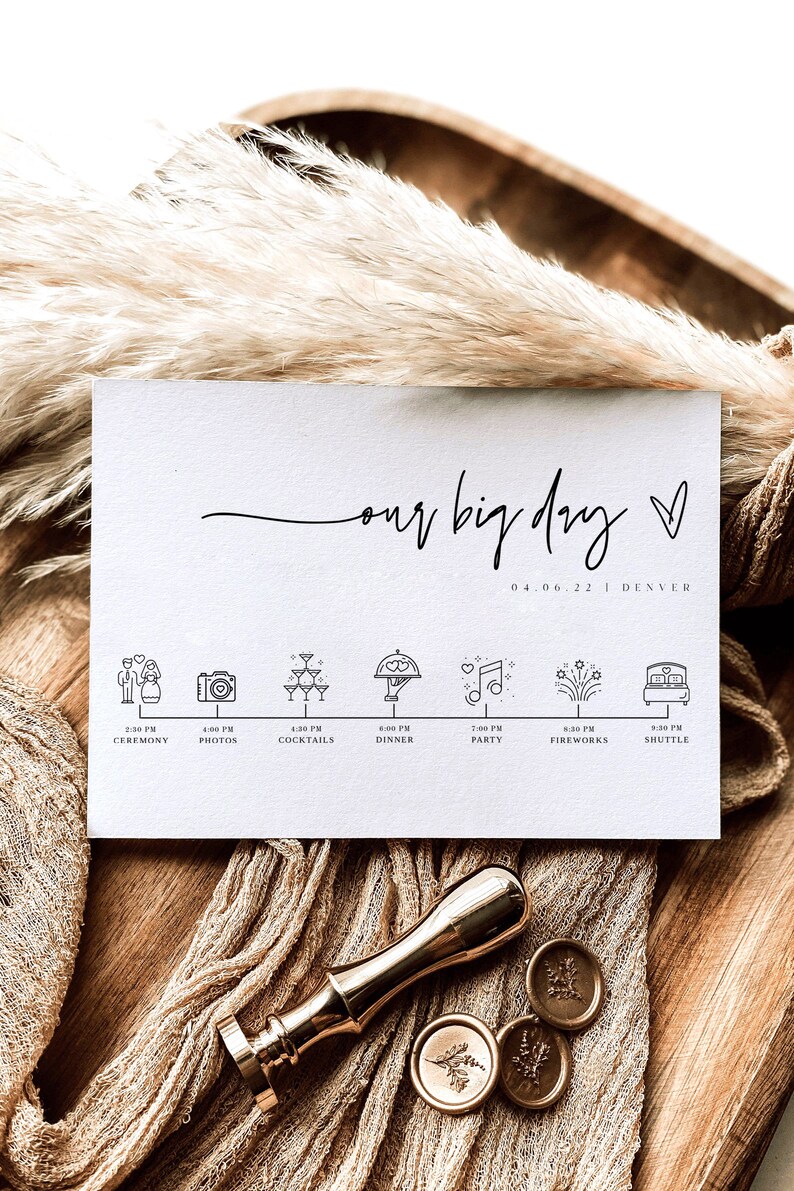 May include: A white card with the text "our big day" in black cursive script. The date "04.06.22" and the location "DENVER" are printed below the text. A timeline of events for the day is listed below, with icons representing each event. The icons include a couple, a camera, champagne glasses, a dinner plate, a musical note, fireworks, and a bed.