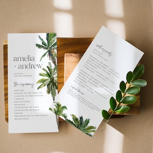 May include: A wedding ceremony program with a tropical theme. The program features a watercolor illustration of palm trees and greenery. The text includes the names Amelia and Andrew, the date 04.06.2022, and the location Denver, Colorado. The ceremony order is listed, including prelude, seating of the families, lighting of the wedding candles, processional, readings, exchanging of vows, exchanging of rings, prayer, presentation of the couple, and recessional.