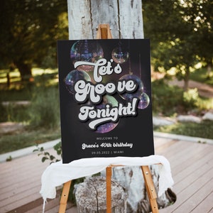 May include: A black welcome sign with a disco ball theme. The sign says "Let's Groove Tonight!" and "Welcome to Grace's 40th birthday 09.05.2022 | Miami".