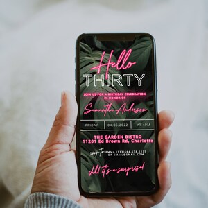 May include: A smartphone screen displaying a birthday party invitation for Samantha Anderson's 30th birthday. The invitation is decorated with tropical leaves and neon pink text that reads "Hello Thirty". The party is scheduled for Friday, 04.06.2022 at 4 PM at The Garden Bistro, 11201 Ed Brown Rd, Charlotte. RSVP to Emma at (333) 564.678.2235 or email@email.com. The text "shh it's a surprise" is also included in neon pink.
