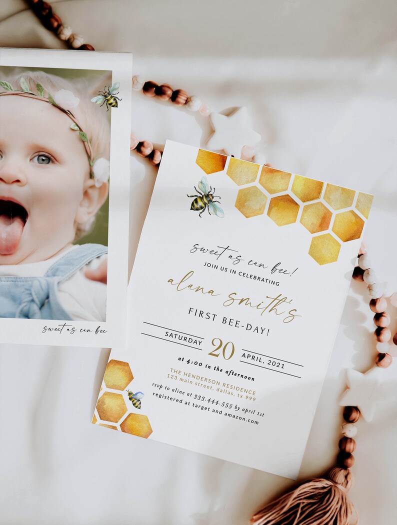 May include: A yellow and white bee-themed first birthday party invitation with a watercolor honeycomb pattern. The invitation reads "Sweet as can bee! Join us in celebrating Alana Smith's First Bee-Day! Saturday, April 20, 2021 at 4:00 in the afternoon. The Henderson Residence, 123 Main Street, Dallas, TX 999. RSVP to Aline at 333-444-555 by April 1st. Registered at Target and Amazon.com."