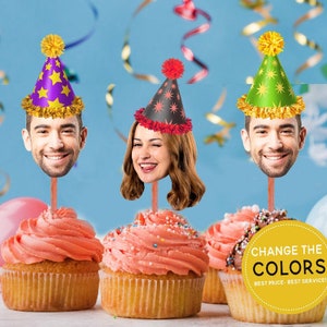 May include: Three cupcakes with pink icing and sprinkles topped with a person's face wearing a party hat. The hats are purple, green, and black with stars. The text on the yellow circle says "Change the Colors, Best Price - Best Service!"