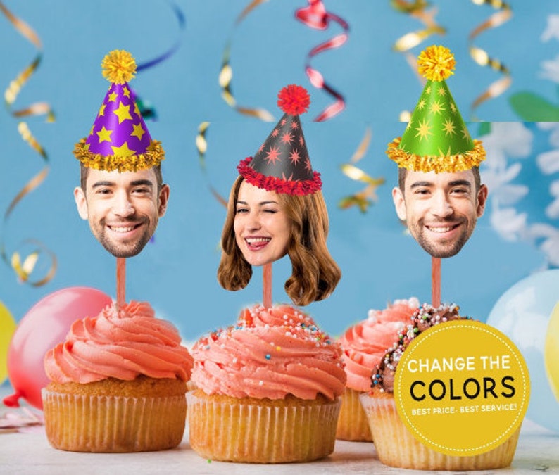 May include: Three cupcakes with pink icing and sprinkles topped with a person's face wearing a party hat. The hats are purple, green, and black with stars. The text on the yellow circle says "Change the Colors, Best Price - Best Service!"