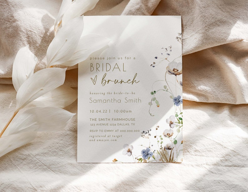 May include: A white card with gold text announcing a bridal brunch for Samantha Smith. The card is decorated with watercolor flowers and greenery. The event is scheduled for 10.04.22 at 10:00am at The Smith Farmhouse, 123 Avenue 1234 Dallas, TX. RSVP to Emmy at 000.000.000. The couple is registered at Target and Amazon.com.