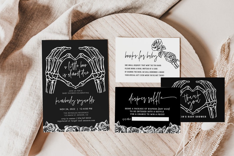 May include: Black and white baby shower invitation with a skeleton hand heart design. The invitation reads "Little Boo is almost due" and includes the date and time of the shower. There are also cards for a diaper raffle and a book request.