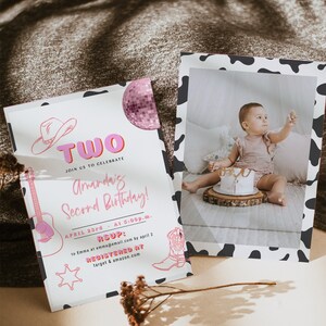May include: A pink and white birthday invitation with a cow print border. The invitation says "Two" in pink letters and "Join us to celebrate Amanda's Second Birthday!" The invitation also includes a pink disco ball, a cowboy hat, a guitar, a cowboy boot, and a sheriff's star. The invitation says "April 23rd at 5:00p.m." and "RSVP: to Emma at emma@email.com by April 2". The invitation also says "Registered at target & amazon.com".