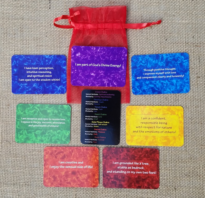 May include: Set of 7 affirmation cards with colorful backgrounds and inspirational messages. Each card features a different affirmation related to personal growth and well-being. The cards are laid out on a burlap surface.