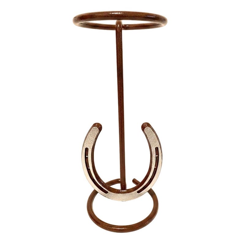 May include: A brown metal horseshoe ring toss game. The game features a circular top and base, with a vertical support and a horseshoe-shaped target. The horseshoe target is silver and brown.