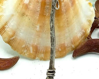 May include: A long, slender, silver-toned metal pendant with a hammered, textured surface. The pendant features a small jump ring at the top for attachment and a decorative coil of wire wrapped around the base, ending in a small, rounded tip.