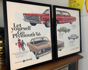 May include: Two framed vintage advertisements for the Plymouth Satellite car. The left ad features a brown car with the text "Let yourself go Plymouth '66". The right ad features a red car with the text "Let yourself go...Plymouth".