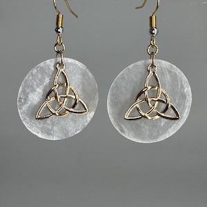 May include: A pair of gold Celtic knot earrings with white, round, translucent, shell-like pendants.