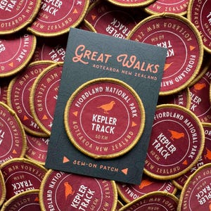 May include: A white ceramic mug with a black handle and the text "But First, Coffee" in a handwritten style. The mug is on a white surface. The mug is approximately 4 inches tall.