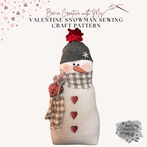 May include: A Valentine's Day snowman sewing craft pattern. The snowman is white with a red heart on its chest and a black and white plaid scarf. The snowman is wearing a black hat with a red pom-pom and a silver snowflake.