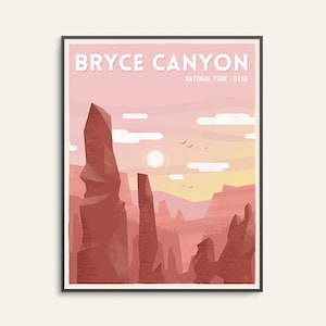 May include: Framed art print featuring a stylized illustration of Bryce Canyon National Park in Utah. The artwork showcases towering red rock formations under a pink and yellow sunset sky, with the text "BRYCE CANYON" at the top.
