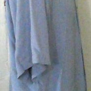 May include: A light blue short-sleeved button-down shirt.