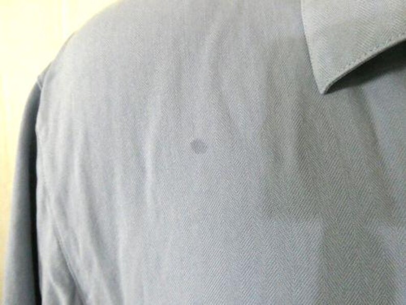 May include: A light blue long-sleeved shirt with a herringbone pattern.