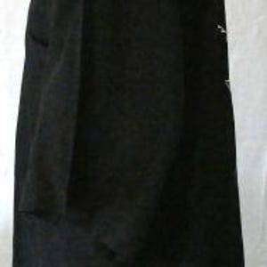 May include: A black short-sleeved blazer with a notched collar. The blazer has a classic design with a button closure and a tailored fit. The fabric appears to be a medium-weight material, suitable for various occasions. The blazer is displayed on a mannequin.