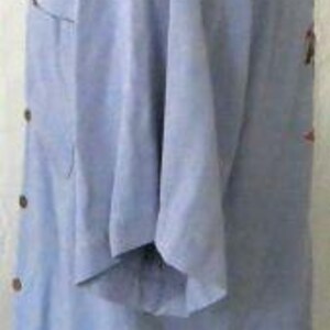 May include: A light blue short-sleeved button-down shirt with a single button cuff. The shirt has a single chest pocket and a collar.