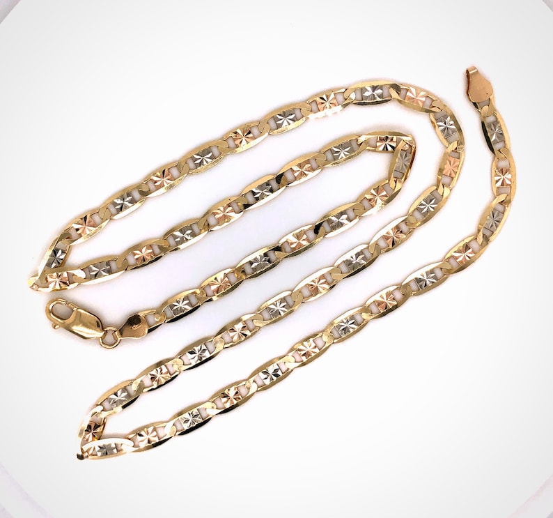 May include: A gold chain necklace with a mariner link design. The chain is made of three different colors of gold: yellow, white, and rose.