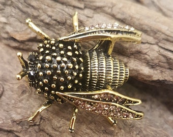 Bumble Bee, Flying Bug Brooch with Rhinestone encrusted wings and black gem eyes.