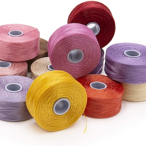 May include: A collection of ten spools of colorful waxed thread, perfect for jewelry making, leather crafting, and other projects. The spools are arranged in a pile, with the colors visible.
