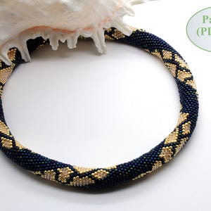 May include: A dark blue and gold beaded necklace with a geometric pattern. The necklace is displayed on a white background.