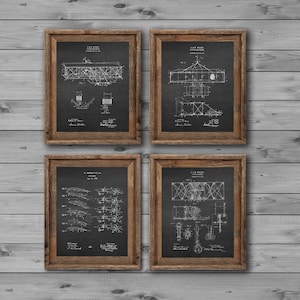 May include: Four black and white vintage airplane patent drawings in brown wood frames on a gray wood wall. The drawings are of different types of airplanes.