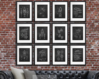 May include: Twelve black framed prints of Star Wars characters and vehicles on a brick wall. The prints are in a grid pattern and feature white line drawings of the characters and vehicles.