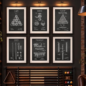 May include: A wall display featuring six framed black and white patent prints of billiards equipment, including balls, cues, and tables. Below the prints, a wooden rack holds five pool cues, a triangle rack, and a small shelf with billiard balls.