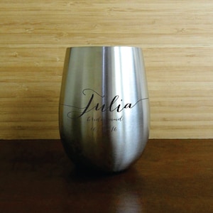 May include: Stainless steel wine tumbler engraved with the name "Julia" and the text "bridesmaid to be".