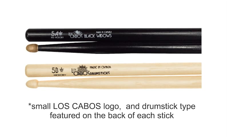 May include: Two pairs of drumsticks, one black and one natural wood. The black pair is labeled "5A Red Hickory" and "Los Cabos Black Widows". The natural wood pair is labeled "5B Hickory" and "Los Cabos Drumsticks". Both pairs have a small Los Cabos logo on the back of each stick.