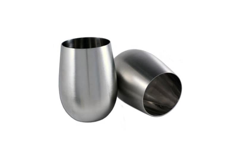 May include: Two stainless steel wine glasses, one is upright and the other is tilted to the side.