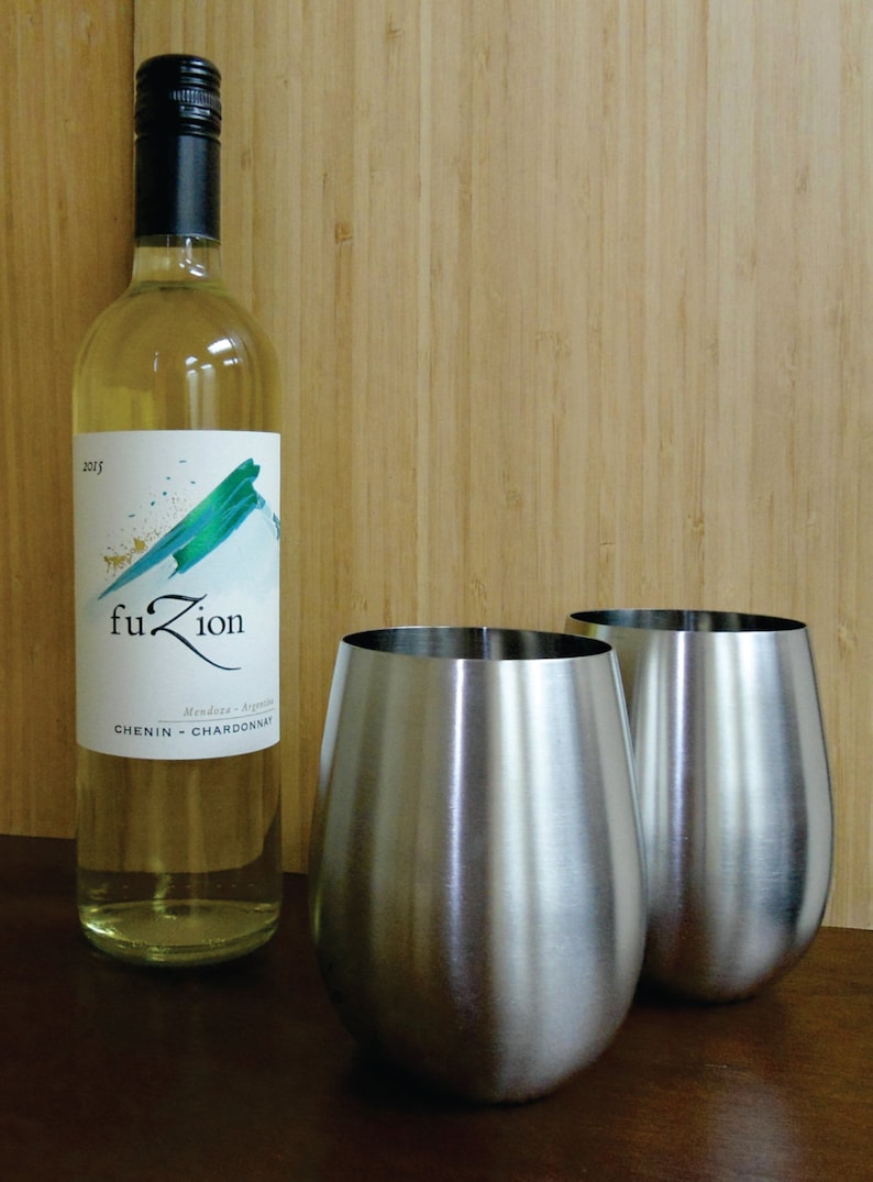 May include: Two stainless steel wine glasses and a bottle of white wine labeled "fuZion" with the text "Mendoza - Argentina" and "CHENIN - CHARDONNAY".