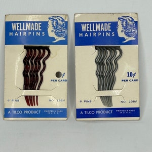 May include: Two cards of hairpins, each featuring a woman's illustration. The card on the left has red hairpins and says "WELLMADE HAIRPINS 6 PINS ¢ PER CARD NO. 238/1 A TILCO PRODUCT PRINTED & MADE IN U.S.A.". The card on the right has grey hairpins and says "WELLMADE HAIRPINS 6 PINS 10¢ PER CARD NO. 238/1 A TILCO PRODUCT PRINTED & MADE IN U.S.A."