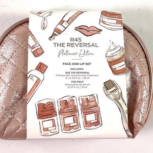 May include: A pink quilted makeup bag with a white label that says "R45 THE REVERSAL Platinum Edition" and includes a face and lip set with a 3-phase skin transforming treatment and a volumizing lip serum.