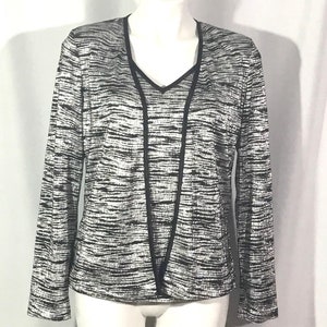 May include: A silver and black long-sleeved top with a v-neck and a black trim. The top has a wavy pattern.