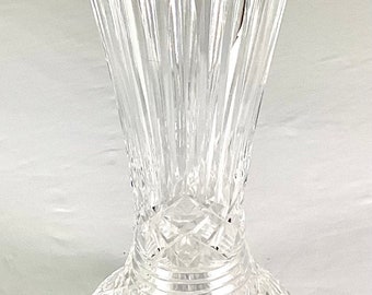 May include: A clear glass vase with a cut crystal design. The vase has a wide mouth and a narrow base.
