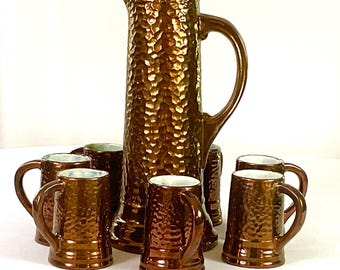 Handcrafted artisan-ceramic-large pitcher and eight tankerds-in a hammered copper luster wear finish