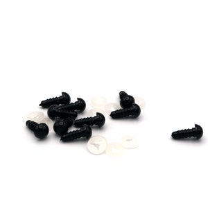 May include: A group of black plastic safety eyes with white plastic washers. The eyes are about 1 cm in diameter and have a screw-on back.