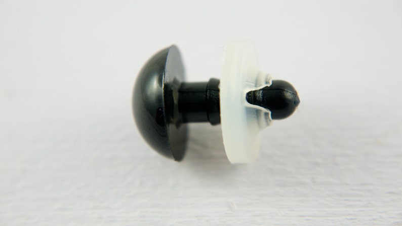 May include: A black plastic safety eye with a white plastic washer. The eye is designed for use in stuffed toys and other crafts.